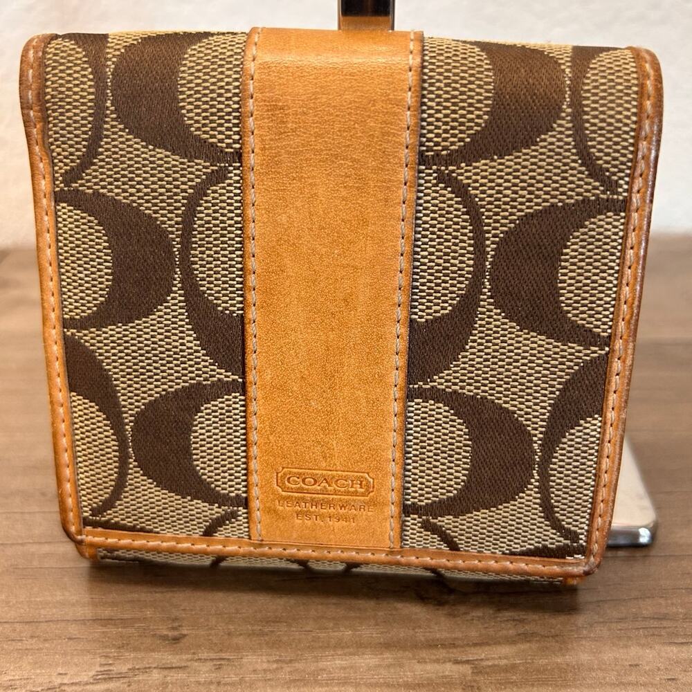 Vintage Coach monogram canvas and leather bi-fold wallet.